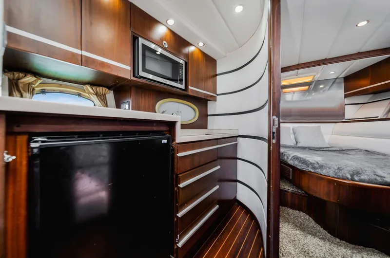 Miss Cathy Yacht Photos Pics Luxurious interior of 2007 Custom NNS Sea Scout 41 yacht with kitchenette and bedroom.