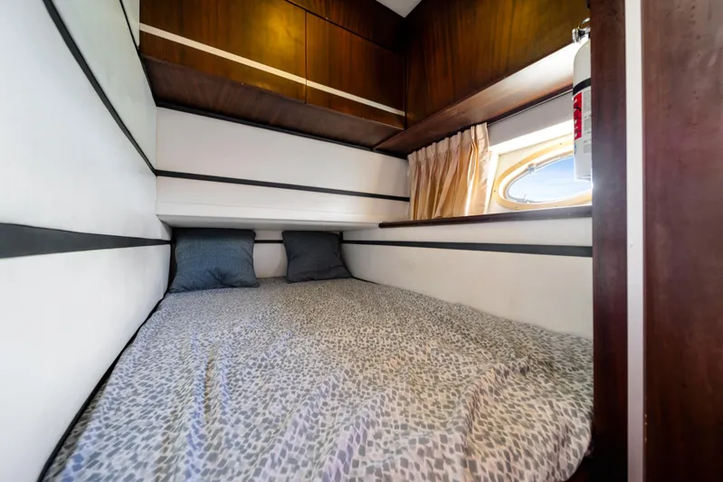 Miss Cathy Yacht Photos Pics Cozy cabin interior of 2007 Custom NNS Sea Scout 41 with bed and window.