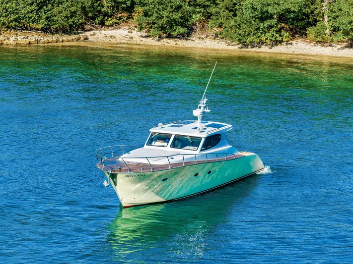 Miss Cathy Yacht Photos Pics Custom NNS Sea Scout 41 yacht cruising near a lush shoreline, 2007 model.