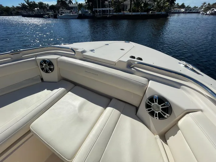  Yacht Photos Pics 2019 Grady-White Freedom 325 boat interior with cushioned seating and speakers on a sunny day.