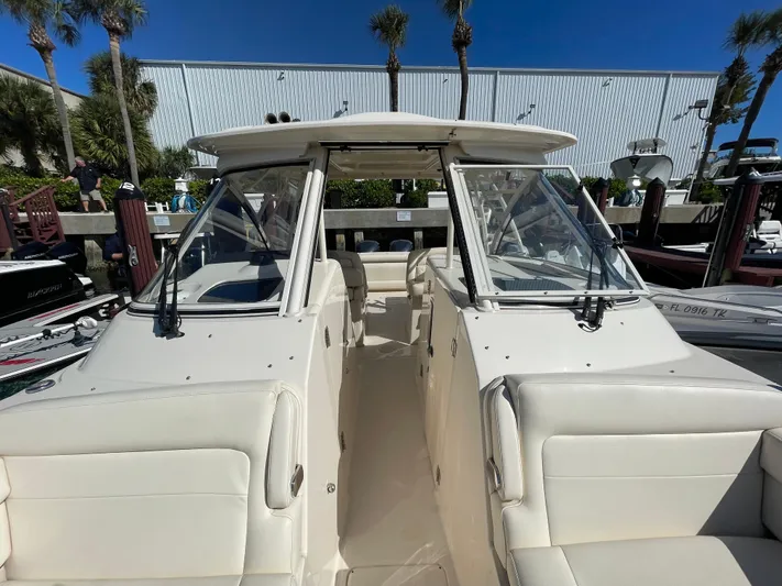  Yacht Photos Pics 2019 Grady-White Freedom 325 boat docked, featuring spacious seating and sleek design.