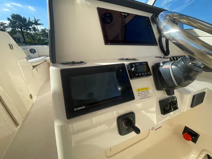  Yacht Photos Pics 2019 Grady-White Freedom 325 boat dashboard with steering wheel and electronic displays.