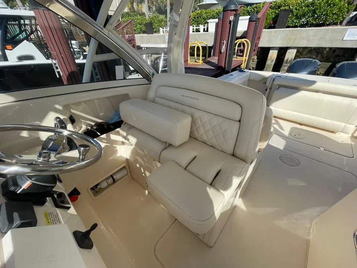  Yacht Photos Pics 2019 Grady-White Freedom 325 boat interior with steering wheel and cushioned seating.