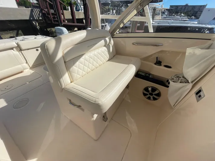  Yacht Photos Pics 2019 Grady-White Freedom 325 boat interior with cream seating and modern amenities.