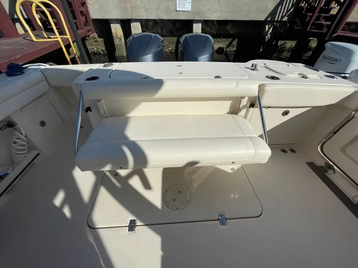  Yacht Photos Pics 2019 Grady-White Freedom 325 boat interior with foldable seating and dual outboard motors.