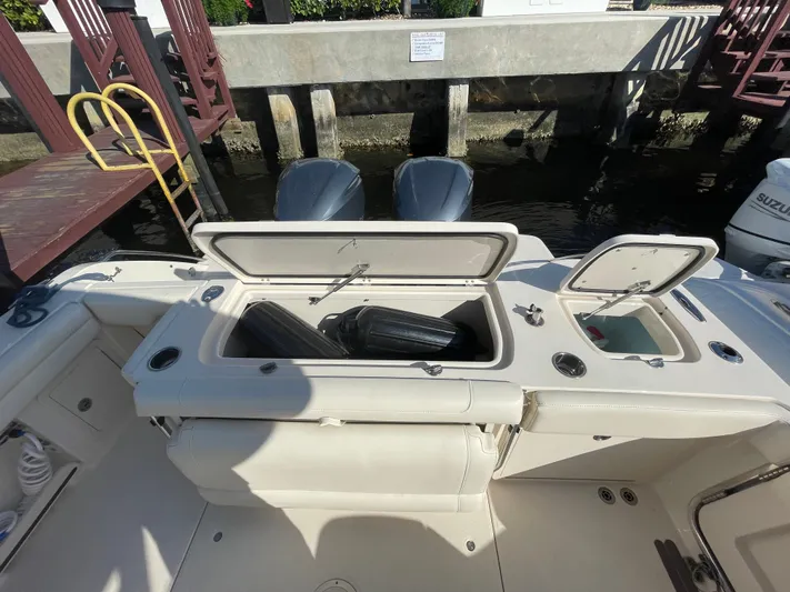  Yacht Photos Pics 2019 Grady-White Freedom 325 boat with open storage compartments at dock.