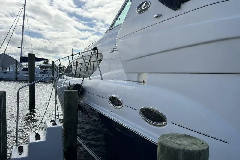 Inconspicuous Yacht Photos Pics 2006 Sea Ray 40 Motor Yacht docked at marina under cloudy sky.