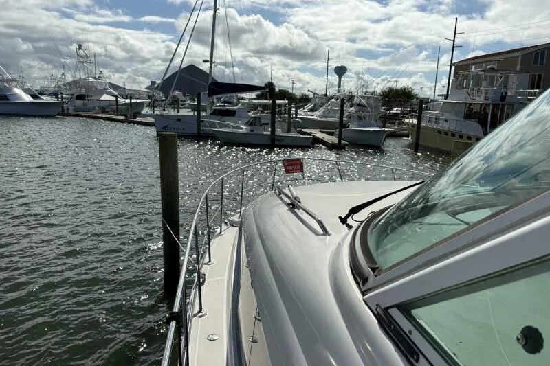 Inconspicuous Yacht Photos Pics 2006 Sea Ray 40 Motor Yacht docked at marina under cloudy sky.
