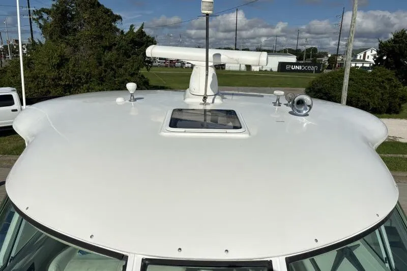 Inconspicuous Yacht Photos Pics 2006 Sea Ray 40 Motor Yacht rooftop with radar and hatch, parked outdoors.