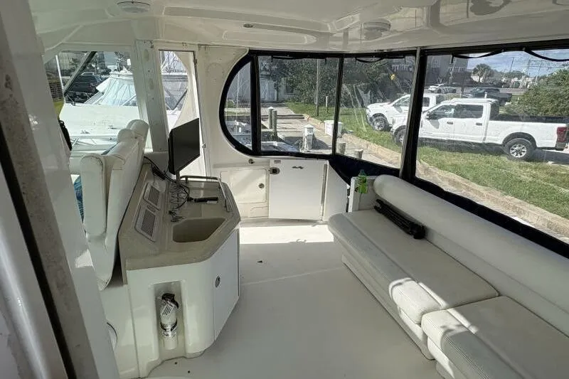 Inconspicuous Yacht Photos Pics Interior of 2006 Sea Ray 40 Motor Yacht with white seating and control panel.