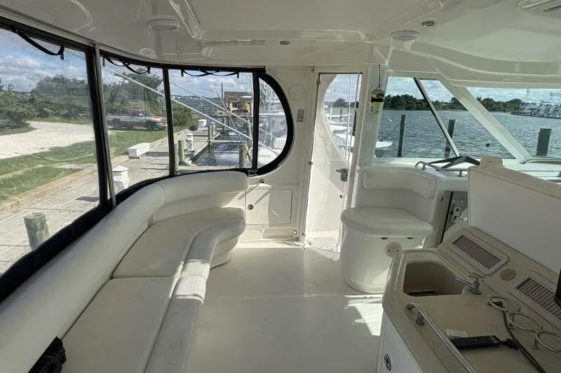 Inconspicuous Yacht Photos Pics Interior of 2006 Sea Ray 40 Motor Yacht with white seating and helm station.