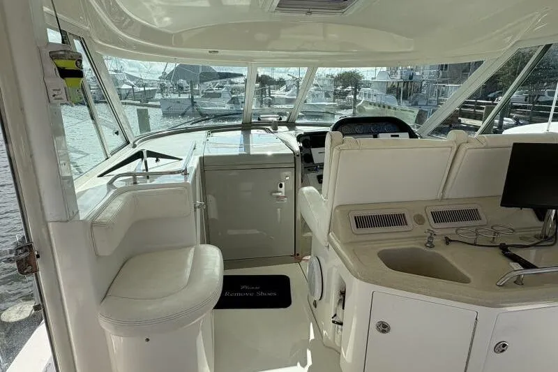 Inconspicuous Yacht Photos Pics 2006 Sea Ray 40 Motor Yacht interior with helm, seating, and sink.