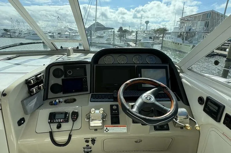 Inconspicuous Yacht Photos Pics 2006 Sea Ray 40 Motor Yacht helm with steering wheel and navigation instruments.