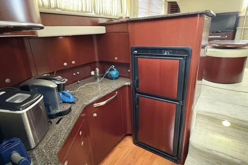 Inconspicuous Yacht Photos Pics 2006 Sea Ray 40 Motor Yacht kitchen with wood cabinetry and modern appliances.