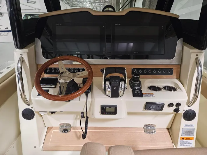 Yacht Photos Pics 2018 Chris-Craft 30 Catalina helm with dual screens, wooden steering wheel, and control panel.
