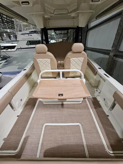  Yacht Photos Pics 2018 Chris-Craft 30 Catalina interior with beige seating and wooden table.