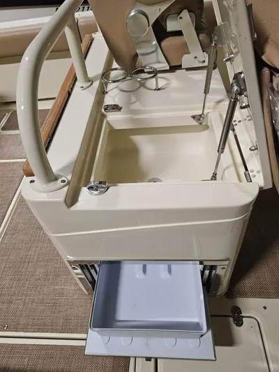  Yacht Photos Pics 2018 Chris-Craft 30 Catalina boat interior with open storage compartment and cup holders.