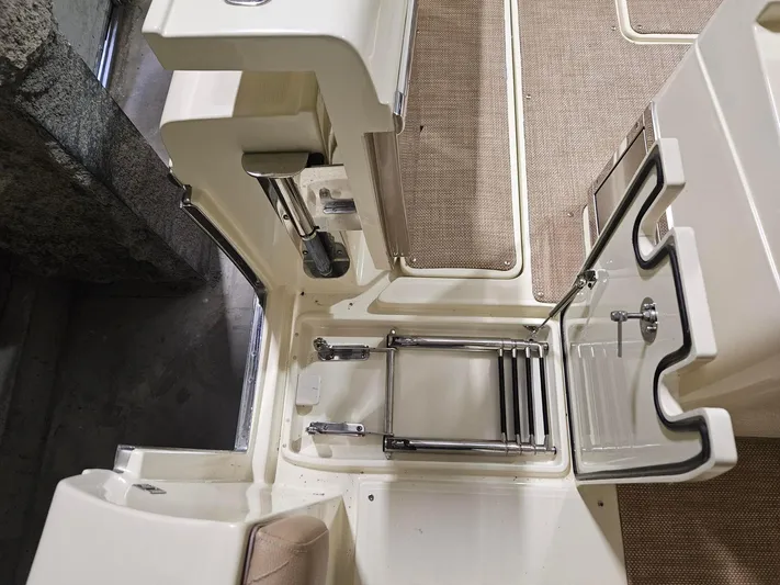  Yacht Photos Pics 2018 Chris-Craft 30 Catalina boat interior with foldable ladder and beige flooring.