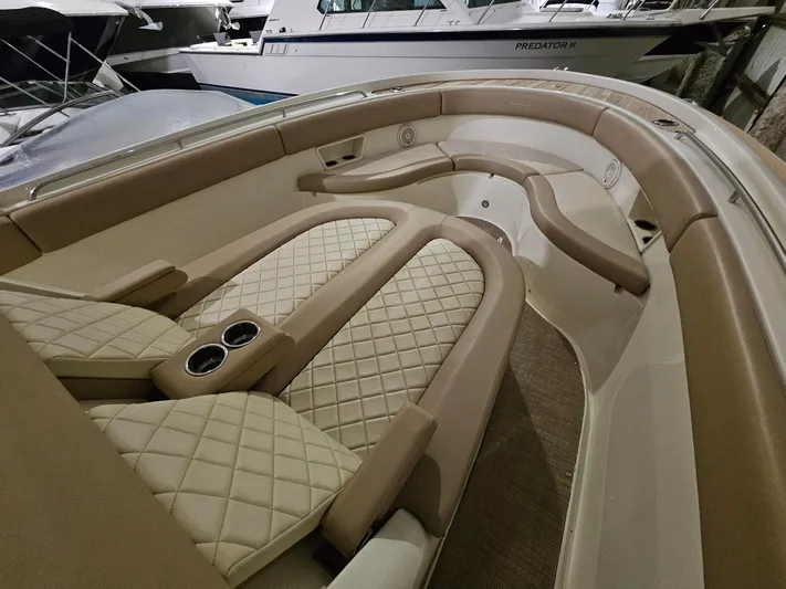  Yacht Photos Pics Luxurious interior of 2018 Chris-Craft 30 Catalina boat with beige quilted seating.