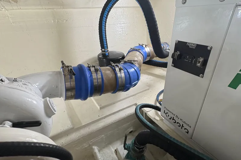 Monkey Business Yacht Photos Pics Engine room of 1988 Egg Harbor 37 Convertible with visible piping and machinery.