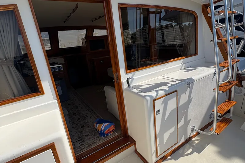 Monkey Business Yacht Photos Pics 1988 Egg Harbor 37 Convertible yacht interior with wooden accents and ladder.