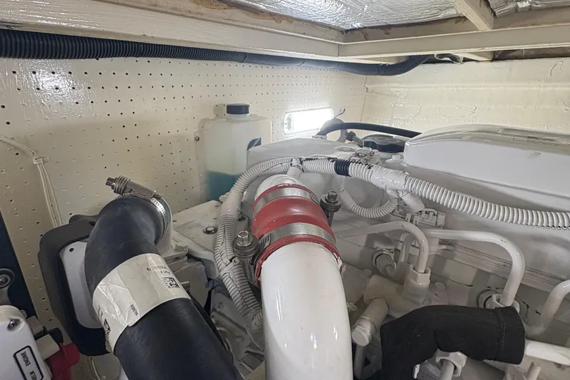 Monkey Business Yacht Photos Pics Engine room of 1988 Egg Harbor 37 Convertible boat, showcasing hoses and components.