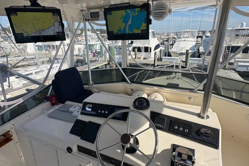 Monkey Business Yacht Photos Pics 1988 Egg Harbor 37 Convertible yacht helm with navigation screens and marina view.