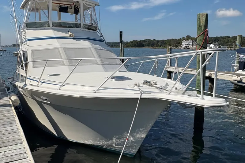 Monkey Business Yacht Photos Pics 1988 Egg Harbor 37 Convertible yacht docked at a marina on a sunny day.