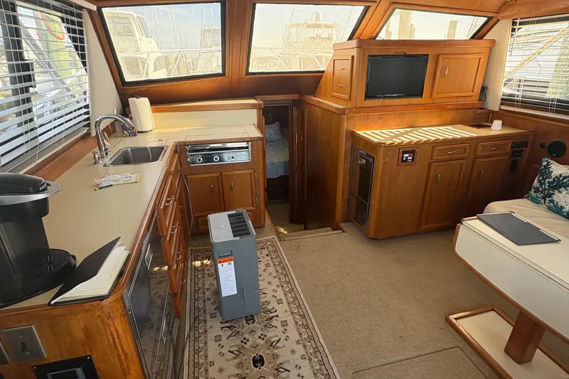 Monkey Business Yacht Photos Pics Interior of 1988 Egg Harbor 37 Convertible yacht with kitchen and seating area.