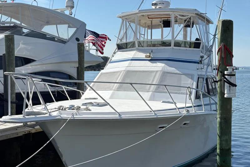 Monkey Business Yacht Photos Pics 1988 Egg Harbor 37 Convertible yacht docked, featuring sleek design and American flag.