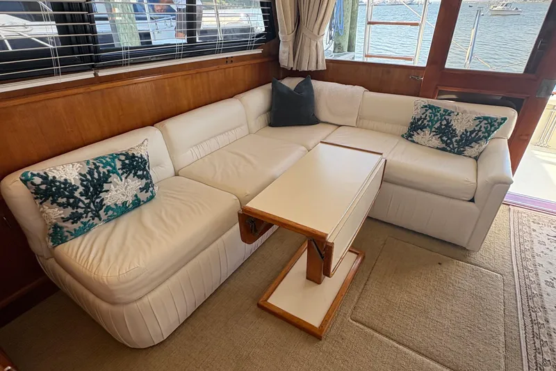 Monkey Business Yacht Photos Pics Luxurious interior of 1988 Egg Harbor 37 Convertible yacht with white leather seating.