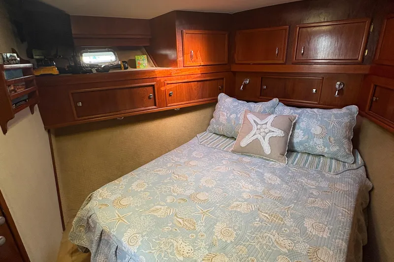Monkey Business Yacht Photos Pics Cozy cabin interior of 1988 Egg Harbor 37 Convertible with nautical-themed bedding.