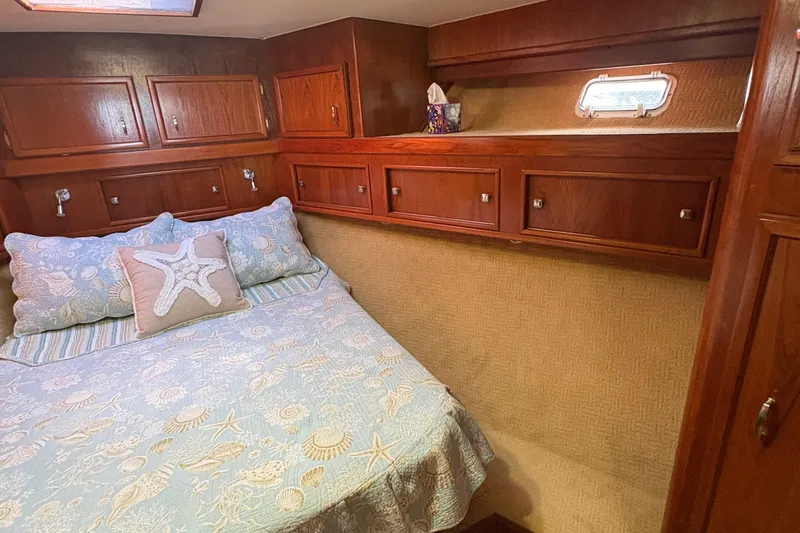 Monkey Business Yacht Photos Pics Cozy cabin interior of 1988 Egg Harbor 37 Convertible with nautical-themed bedding.
