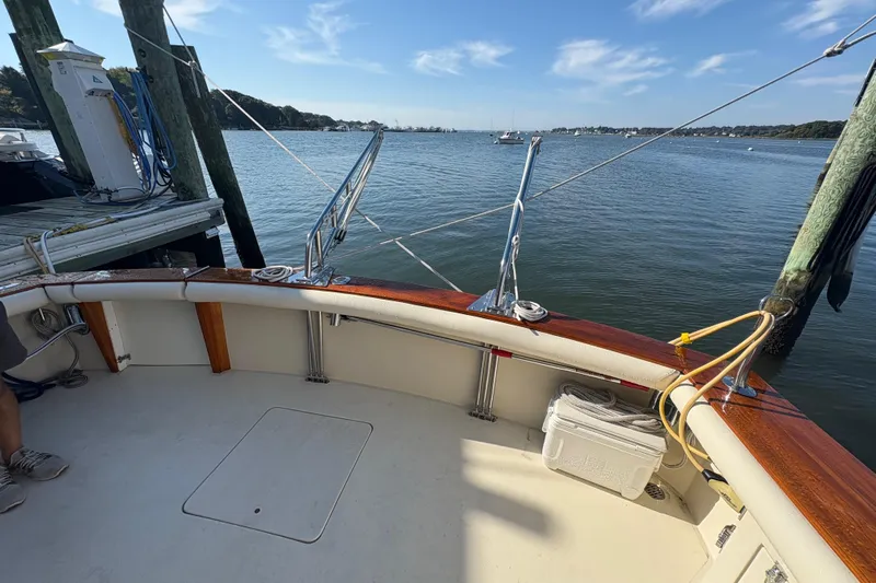 Monkey Business Yacht Photos Pics 1988 Egg Harbor 37 Convertible boat docked, featuring a spacious deck and scenic water view.