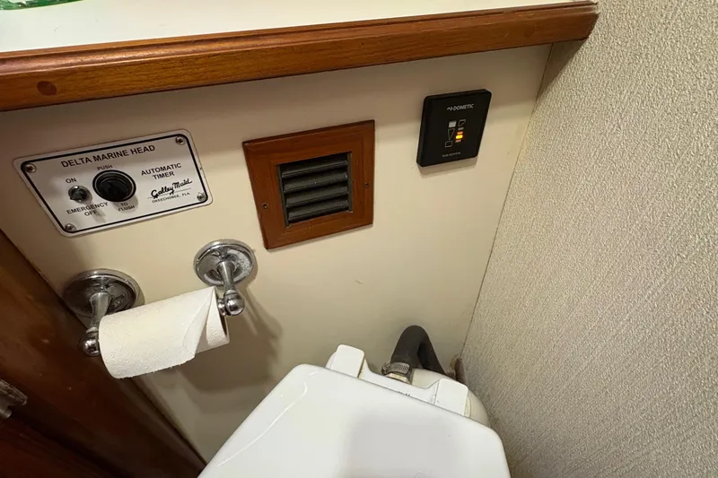 Monkey Business Yacht Photos Pics 1988 Egg Harbor 37 Convertible bathroom with Delta Marine Head controls and toilet paper holder.