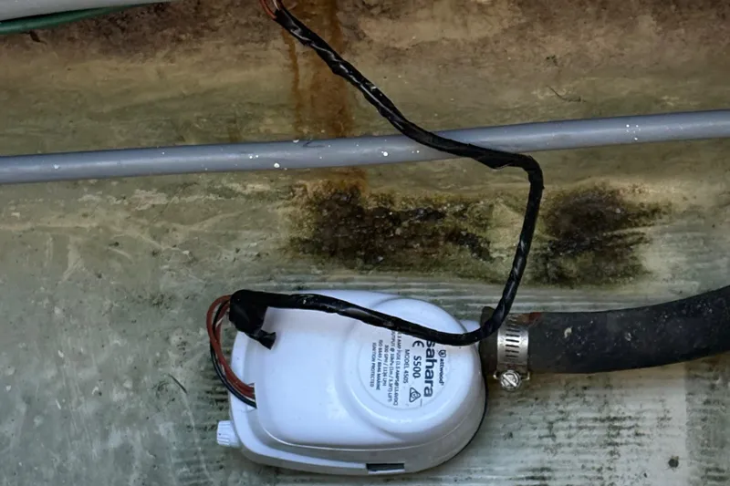 Monkey Business Yacht Photos Pics Bilge pump in 1988 Egg Harbor 37 Convertible boat, with visible wiring and hose.