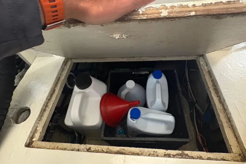 Monkey Business Yacht Photos Pics Storage compartment on 1988 Egg Harbor 37 Convertible with containers and funnel.