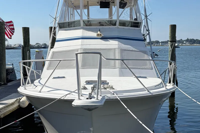 Monkey Business Yacht Photos Pics 1988 Egg Harbor 37 Convertible yacht docked, featuring sleek design and spacious deck.