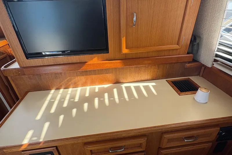 Monkey Business Yacht Photos Pics Interior of 1988 Egg Harbor 37 Convertible yacht with TV and wooden cabinetry.