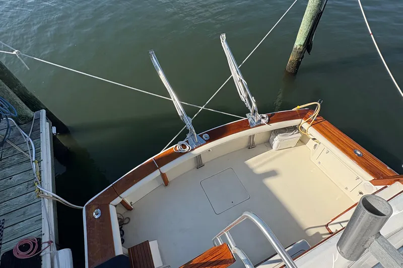 Monkey Business Yacht Photos Pics 1988 Egg Harbor 37 Convertible boat deck, docked with polished wood accents.