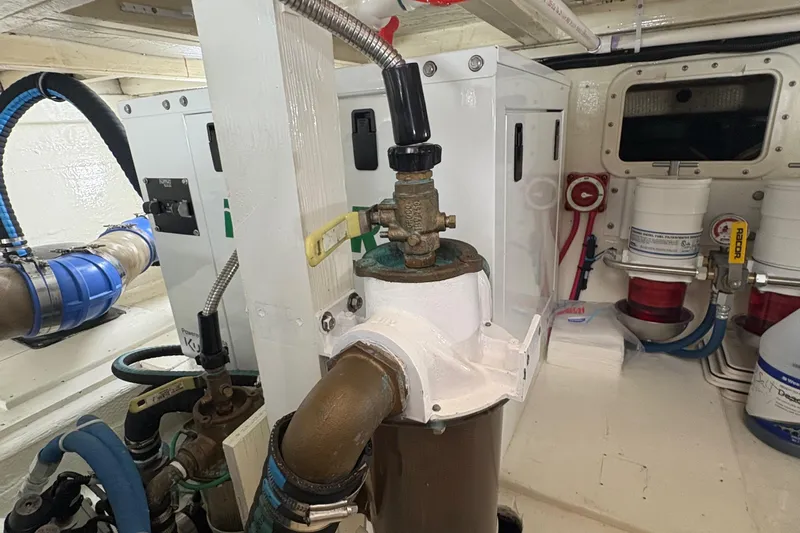 Monkey Business Yacht Photos Pics Engine room of 1988 Egg Harbor 37 Convertible boat, showcasing mechanical components and piping.