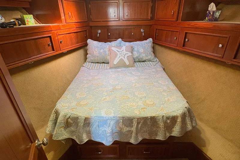 Monkey Business Yacht Photos Pics Cozy cabin bedroom in 1988 Egg Harbor 37 Convertible yacht with nautical-themed bedding.