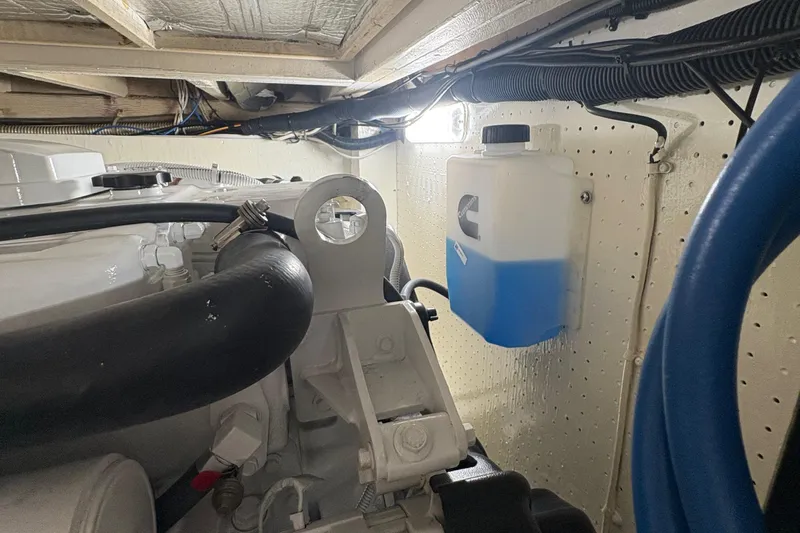 Monkey Business Yacht Photos Pics Engine room of 1988 Egg Harbor 37 Convertible with coolant reservoir and hoses.