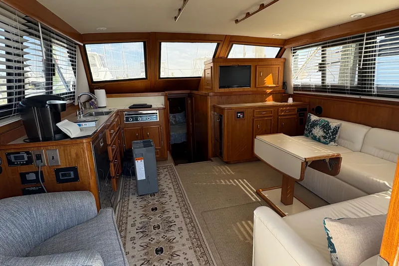 Monkey Business Yacht Photos Pics Interior of 1988 Egg Harbor 37 Convertible yacht with wood cabinetry and seating area.