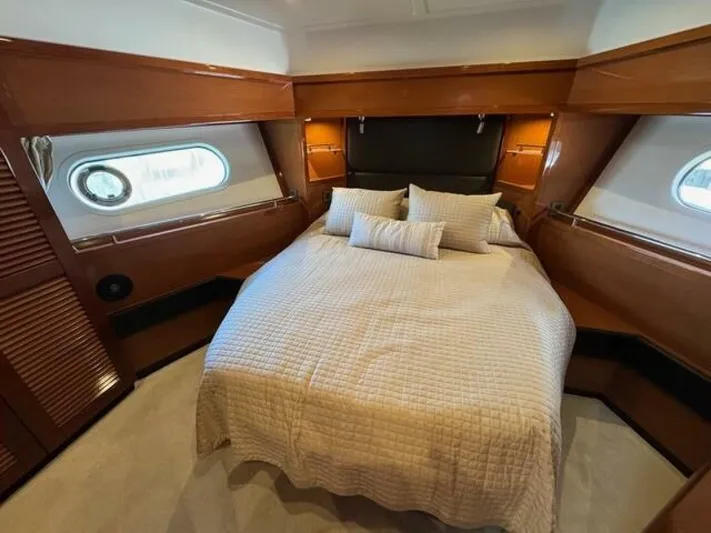 Candy Girl Yacht Photos Pics Luxurious cabin interior of 2017 Beneteau Swift Trawler 50 with cozy bed and elegant wood finish.