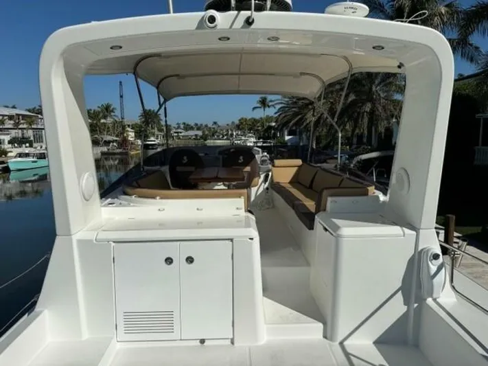 Candy Girl Yacht Photos Pics 2017 Beneteau Swift Trawler 50 with spacious deck and seating, docked in a sunny marina.