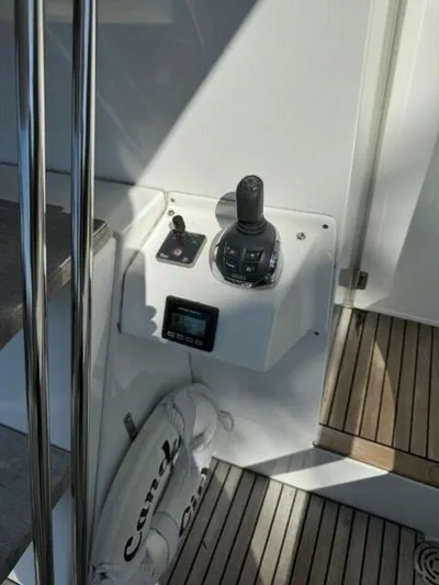Candy Girl Yacht Photos Pics 2017 Beneteau Swift Trawler 50 control panel with joystick and wooden deck.
