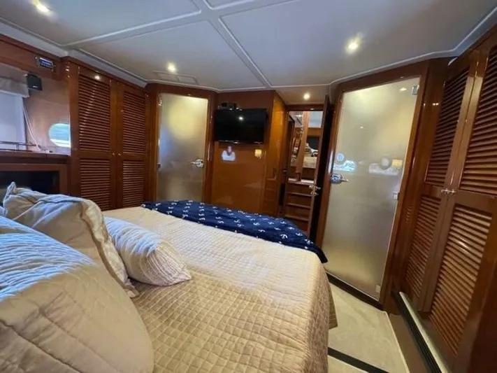 Candy Girl Yacht Photos Pics Luxurious cabin interior of 2017 Beneteau Swift Trawler 50 with cozy bedding.