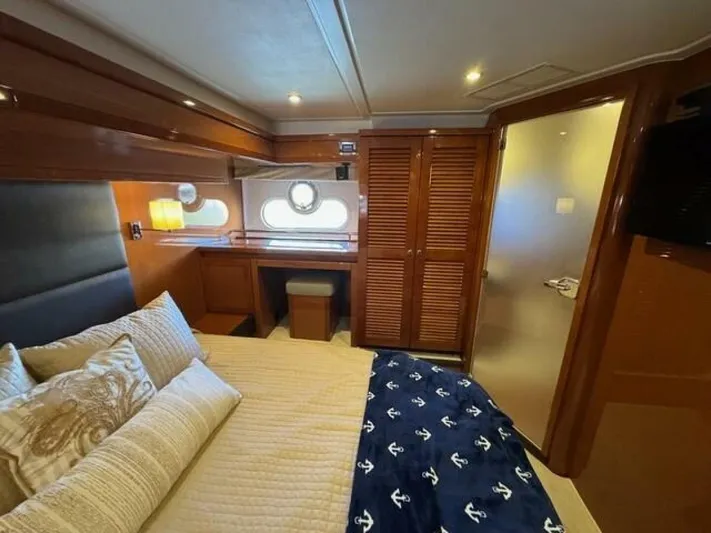 Candy Girl Yacht Photos Pics Luxurious cabin interior of 2017 Beneteau Swift Trawler 50 with elegant bedding and wooden finishes.