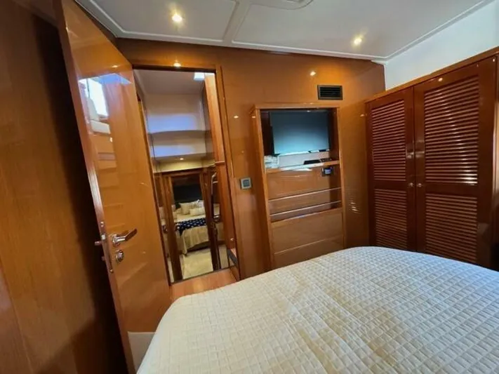 Candy Girl Yacht Photos Pics 2017 Beneteau Swift Trawler 50 cabin interior with wood finish and cozy bedding.